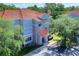 Three-story multi-Gathering home with a balcony and manicured landscaping at 18001 Richmond Place Dr # 337, Tampa, FL 33647