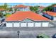 Garage building with a red tile roof and gray walls offering convenient parking at 18001 Richmond Place Dr # 337, Tampa, FL 33647