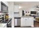 Modern kitchen featuring stainless steel appliances, white cabinets, and granite countertops with an open view into the living space at 18001 Richmond Place Dr # 337, Tampa, FL 33647