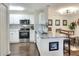 Modern kitchen featuring stainless steel appliances, white cabinets, and granite countertops with an open view into the living space at 18001 Richmond Place Dr # 337, Tampa, FL 33647