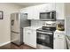 Bright kitchen with stainless steel appliances and granite countertops with modern fixtures at 18001 Richmond Place Dr # 337, Tampa, FL 33647