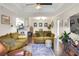 Comfortable living room with tray ceilings, ceiling fan, and dark wood floors open to kitchen at 18001 Richmond Place Dr # 337, Tampa, FL 33647