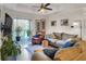 A cozy living room with a balcony, comfortable seating, and a view of the outdoors at 18001 Richmond Place Dr # 337, Tampa, FL 33647