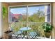 Relaxing outdoor patio with green furniture and plants with a view of neighboring buildings and blue skies at 18001 Richmond Place Dr # 337, Tampa, FL 33647