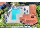 Aerial view of the large pool and surrounding patio area with palm trees and parking at 18001 Richmond Place Dr # 337, Tampa, FL 33647
