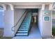 Condo stairwell featuring painted stairs and railings leading to upper-level units and exit at 18001 Richmond Place Dr # 337, Tampa, FL 33647