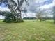 Large backyard with mature trees and landscaping at 1909 Masters Way, Plant City, FL 33566