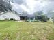 Large backyard with a screened pool enclosure attached to the rear of the home at 1909 Masters Way, Plant City, FL 33566