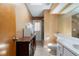 Bathroom with toilet, sink, wood cabinets and walk-in shower at 1909 Masters Way, Plant City, FL 33566