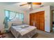 Bedroom with bed, closet, ceiling fan, and blue curtains at 1909 Masters Way, Plant City, FL 33566