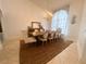 Formal dining area with a rustic wood table, elegant chairs, and a decorative chandelier, creating a sophisticated atmosphere at 1909 Masters Way, Plant City, FL 33566
