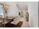 Elegant dining room with a rustic wooden table, upholstered chairs, and a decorative chandelier at 1909 Masters Way, Plant City, FL 33566