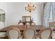 Spacious dining room with a large wooden table, upholstered chairs, and a stylish chandelier at 1909 Masters Way, Plant City, FL 33566