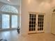 Elegant foyer featuring decorative glass doors, tile flooring, and an open entryway, creating a welcoming ambiance at 1909 Masters Way, Plant City, FL 33566
