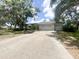 Beautiful single-story home with a two-car garage, a wide driveway, and mature trees providing ample shade at 1909 Masters Way, Plant City, FL 33566