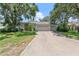 Charming single-story home featuring a two-car garage, mature trees, and a well-manicured front lawn at 1909 Masters Way, Plant City, FL 33566