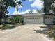 Charming single-story home with a spacious driveway and a two-car garage, complemented by lush landscaping at 1909 Masters Way, Plant City, FL 33566