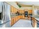 Bright kitchen features wooden cabinets, granite counters, stainless steel appliances, and tiled floors at 1909 Masters Way, Plant City, FL 33566