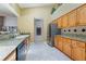 Well lit kitchen features wooden cabinets, granite countertops and stainless steel appliances at 1909 Masters Way, Plant City, FL 33566