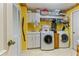 Well-organized laundry room features tiled floor and included washer and dryer for added convenience at 1909 Masters Way, Plant City, FL 33566