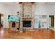 Cozy living room featuring a brick fireplace and built-in shelving at 1909 Masters Way, Plant City, FL 33566