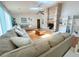 Expansive living room with a brick fireplace, wood floors and a ceiling fan at 1909 Masters Way, Plant City, FL 33566