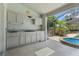 Outdoor kitchen with counter space located on the screened lanai with a great view of the pool at 1909 Masters Way, Plant City, FL 33566