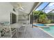 Outdoor kitchen with counter space located on the screened lanai with a great view of the pool at 1909 Masters Way, Plant City, FL 33566