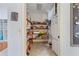Walk-in pantry with organized shelving and additional refrigerator at 1909 Masters Way, Plant City, FL 33566