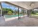 Relaxing screened-in pool area with a hot tub, palm trees and overlooking a green fairway at 1909 Masters Way, Plant City, FL 33566