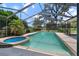 Relaxing screened-in pool area with a hot tub, palm trees and overlooking a green fairway at 1909 Masters Way, Plant City, FL 33566