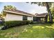 Exterior view of the home showing the backyard and screened porch area at 2223 Wildwood Hollow Dr, Valrico, FL 33596
