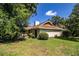 A well manicured backyard surrounding the home's exterior, including the porch at 2223 Wildwood Hollow Dr, Valrico, FL 33596