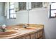 Bathroom vanity with a double sink and natural wood countertop at 2223 Wildwood Hollow Dr, Valrico, FL 33596