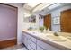 Bathroom featuring dual sinks, vanity with a large mirror, and decorative wall art at 2223 Wildwood Hollow Dr, Valrico, FL 33596