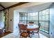Bright breakfast nook boasts a bay window, wooden table, and seating for four at 2223 Wildwood Hollow Dr, Valrico, FL 33596