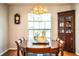 Classic dining room with traditional furniture, chandelier and large windows at 2223 Wildwood Hollow Dr, Valrico, FL 33596