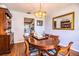 Elegant dining area features a laminate wood floor, a swan centerpiece, and stylish furnishings at 2223 Wildwood Hollow Dr, Valrico, FL 33596
