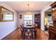 Formal dining room with laminate floors, classic chandelier, and seating for six at 2223 Wildwood Hollow Dr, Valrico, FL 33596