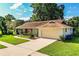 Charming single-story home features a well-manicured lawn, attached garage, and inviting curb appeal at 2223 Wildwood Hollow Dr, Valrico, FL 33596