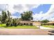 Traditional single-story home features mature landscaping and a two-car garage at 2223 Wildwood Hollow Dr, Valrico, FL 33596