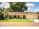 Charming single-story home with stone accents, a lush lawn, and a two-car garage at 2223 Wildwood Hollow Dr, Valrico, FL 33596