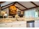 Kitchen view to stone fireplace in living room at 2223 Wildwood Hollow Dr, Valrico, FL 33596