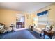 Cozy living room features blue carpet and access to formal dining room at 2223 Wildwood Hollow Dr, Valrico, FL 33596