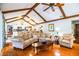 Inviting living room featuring vaulted ceilings with wood beams and an open flow to the kitchen at 2223 Wildwood Hollow Dr, Valrico, FL 33596
