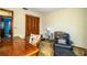 A simple office space with dark-stained wood trim and a comfortable chair at 2223 Wildwood Hollow Dr, Valrico, FL 33596