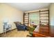 A comfortable office space with wooden bookshelves and a plush chair and ottoman at 2223 Wildwood Hollow Dr, Valrico, FL 33596