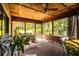 Relaxing screened-in porch with hanging swing, seating, and views of the lush yard at 2223 Wildwood Hollow Dr, Valrico, FL 33596
