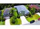 Charming two-story home boasts a well-manicured lawn, complemented by lush landscaping and a lengthy driveway at 2721 Walden Woods Dr, Plant City, FL 33566