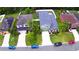 Overhead shot showcases a neighborhood with tidy lawns, palm trees, and colorful cars parked along the street at 2721 Walden Woods Dr, Plant City, FL 33566